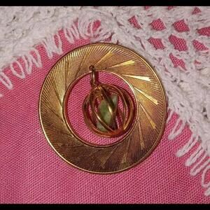Vintage Gold Tone Circle Brooch with Dangling Caged Green Stone. Pin